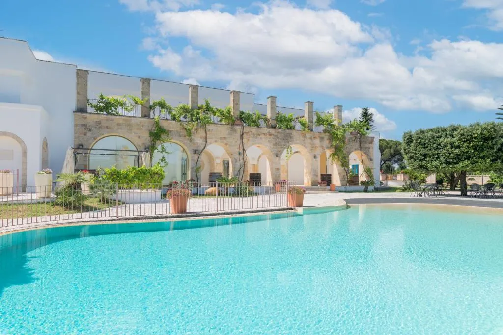 Relais Porta del Sud — heated outdoor pool at dusk in Ostuni, Puglia